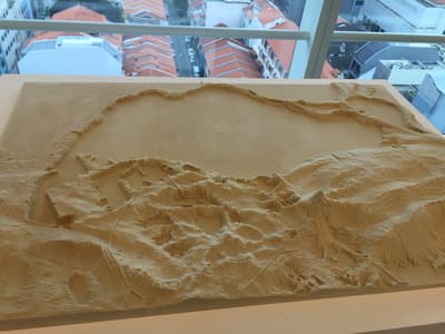 An artistic sand sculpture representing the island of Singapore.
