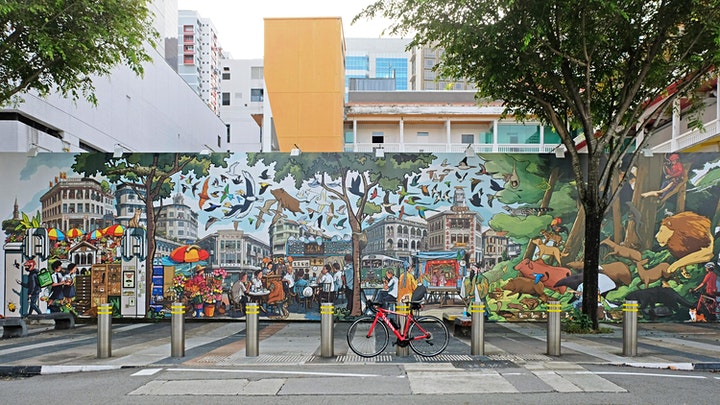 A photo of a colourful city-scape mural.