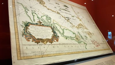 A photo of an old nautical map on display.