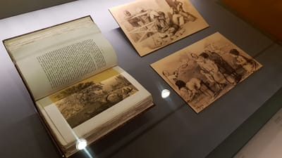 A close-up of a journal and various sepia sketches of everyday street life in early Singapore.