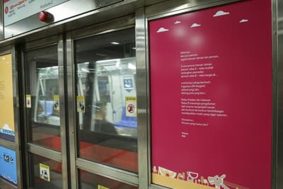 A close-up of one of the poems on a MRT door.