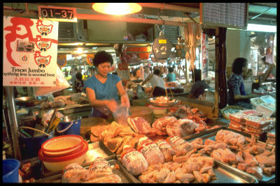A woman running her chicken stall in Tanjong Pagar wet market.